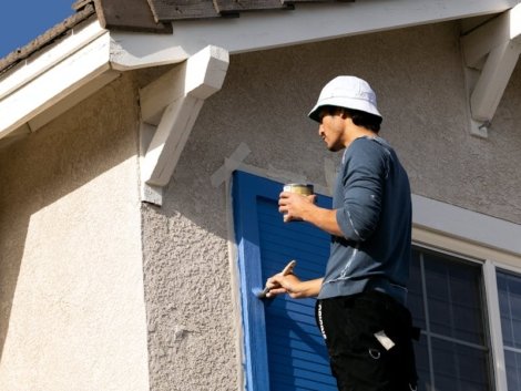 Man Painting the Window Shutter