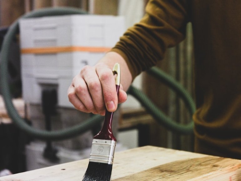 person holding black and white paint brush